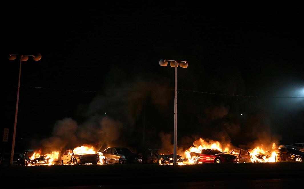 A row of cars burn at a used car lot during a demonstration on Nov. 25, 2014, in Ferguson, Missouri