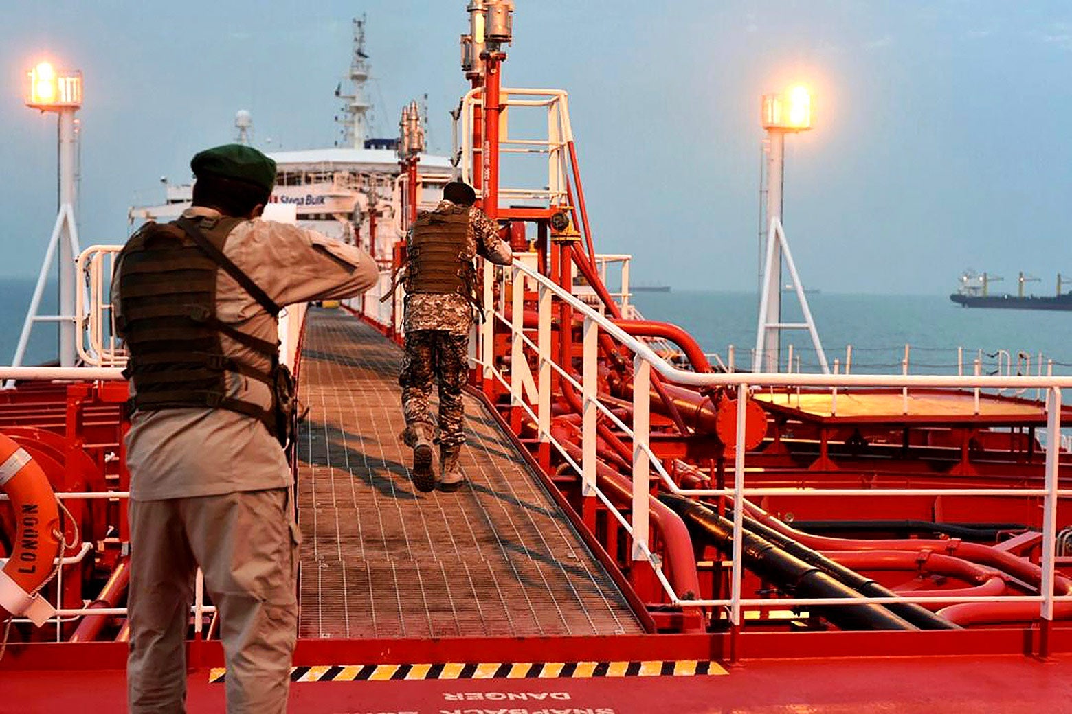 Two armed members of Iran’s Revolutionary Guard inspect the British-flagged oil tanker Stena Impero.