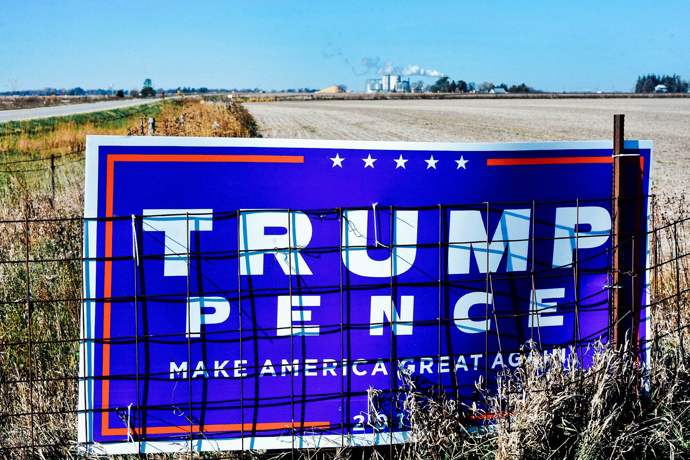 A Trump-Pence sign in front of a field.
