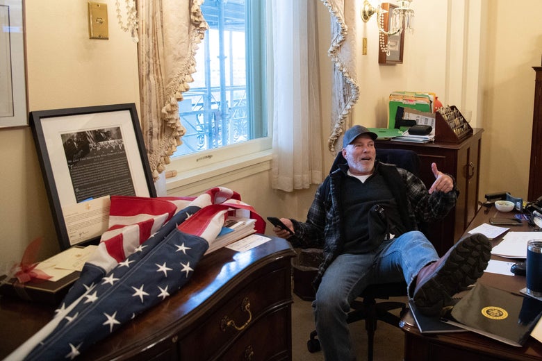 Richard Barnett sits inside the office of Speaker of the House Nancy Pelosi in Washington, D.C. on January 6, 2021.