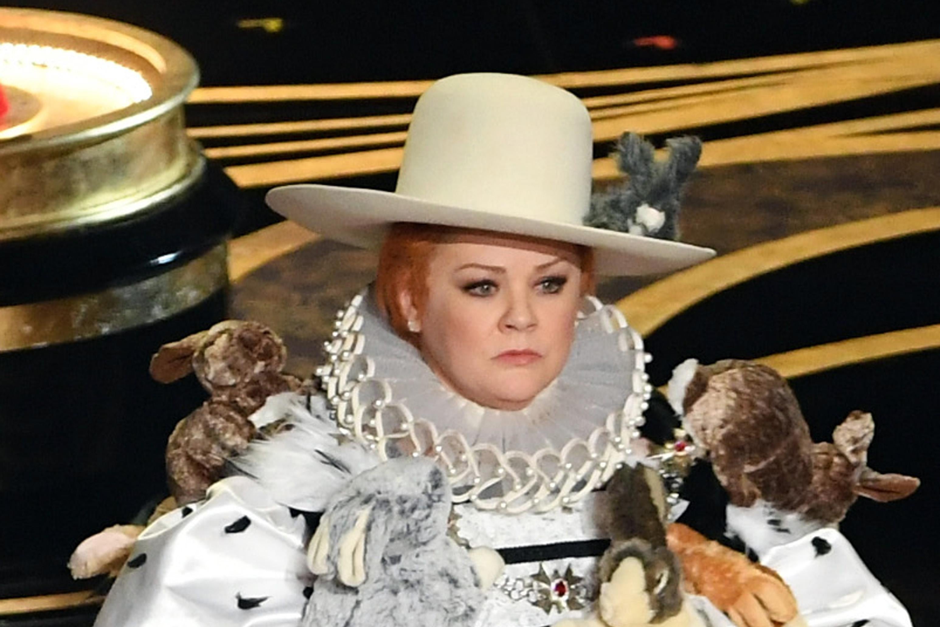 A close-up of Melissa McCarthy in costume. Her wide-brimmed hat has a stuffed rabbit on it.