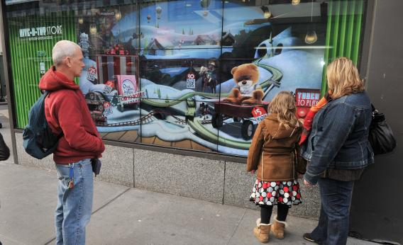 EBay's new "shoppable storefronts" will let customers buy items on a touchscreen display on the front windows of vacant storefronts. Pictured above is a 2011 eBay initiative called the "Give-a-Toy Store," which let shoppers in New York City's Herald Square donate to Toys for Tots from their mobile devices using QR codes. 