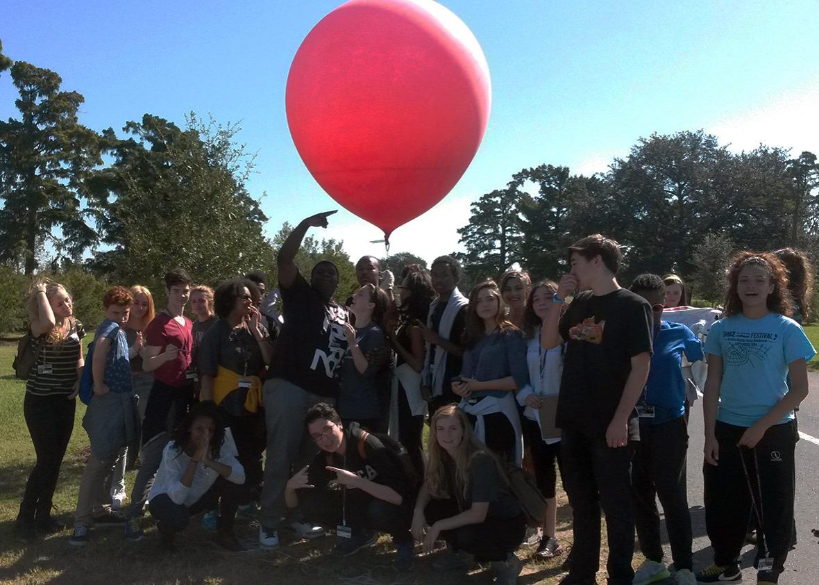 Students in Travis Haas’s class at the New Orleans Center for Creative Arts, with one of the red helium balloons they use to monitor pollution and the progress of wetlands recovery