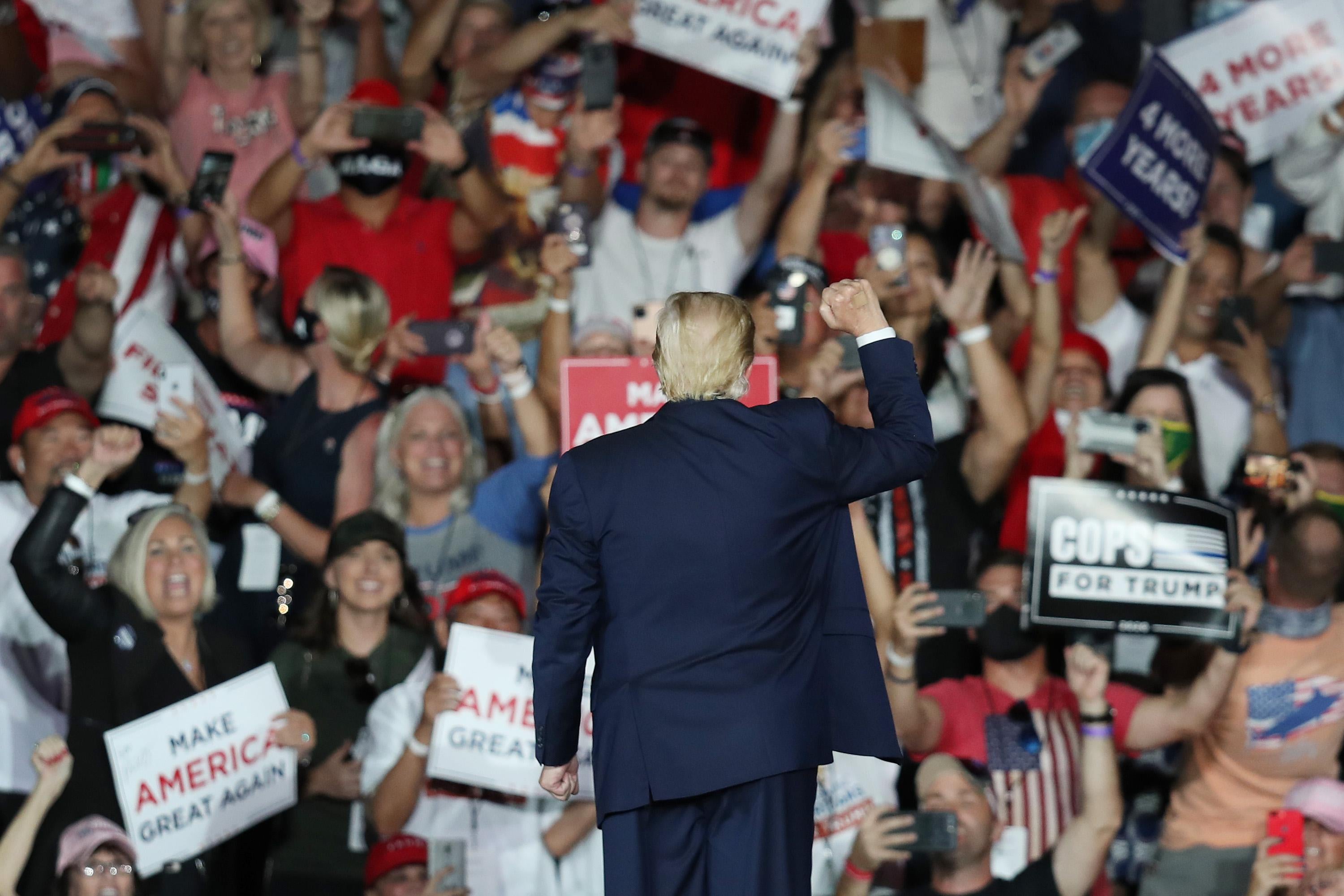 President Donald Trump waves to the crowd as he leaves after speaking during a campaign event at the Orlando Sanford International Airport on October 12, 2020 in Sanford, Florida. 