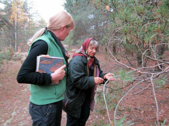 Author Mary Mycio (L) author of "Wormwood Forest: A Natural History of Chernobyl" with Valentina, 65, pointing out the healing herbs in a special spot of the forest.