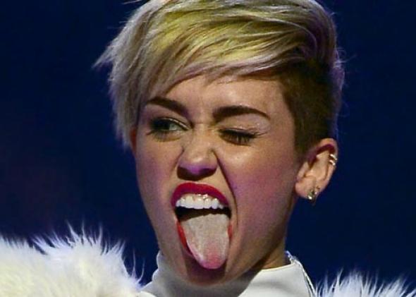 Entertainer Miley Cyrus winks and sticks out her tongue as she performs during the iHeartRadio Music Festival at the MGM Grand Garden Arena on September 21, 2013 in Las Vegas, Nevada. 