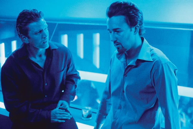 Barry Pepper and Edward Norton speak in a blue-lit bathroom.