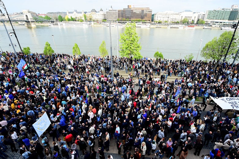 A crowd of protesters near a river.