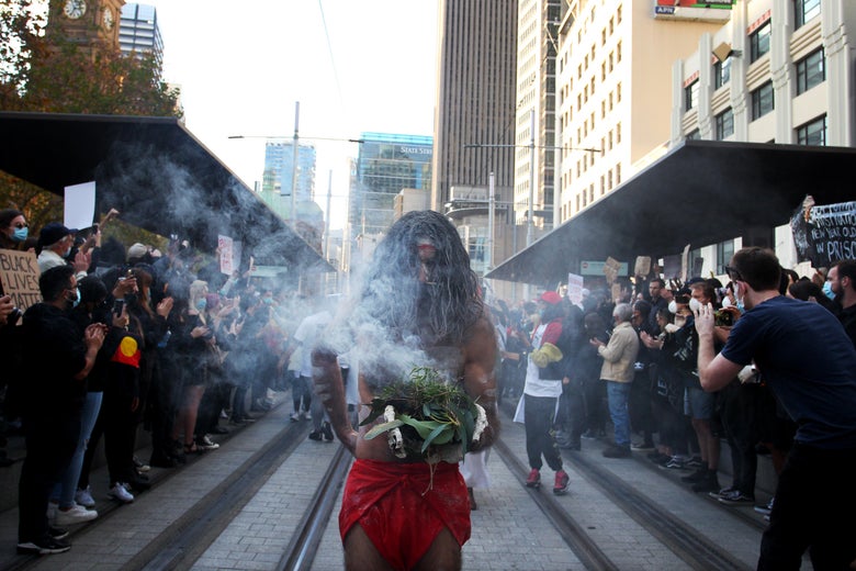 Aboriginal elders conduct a traditional smoking ceremony at Town Hall during a Black Lives Matter protest march on June 6, 2020 in Sydney, Australia.