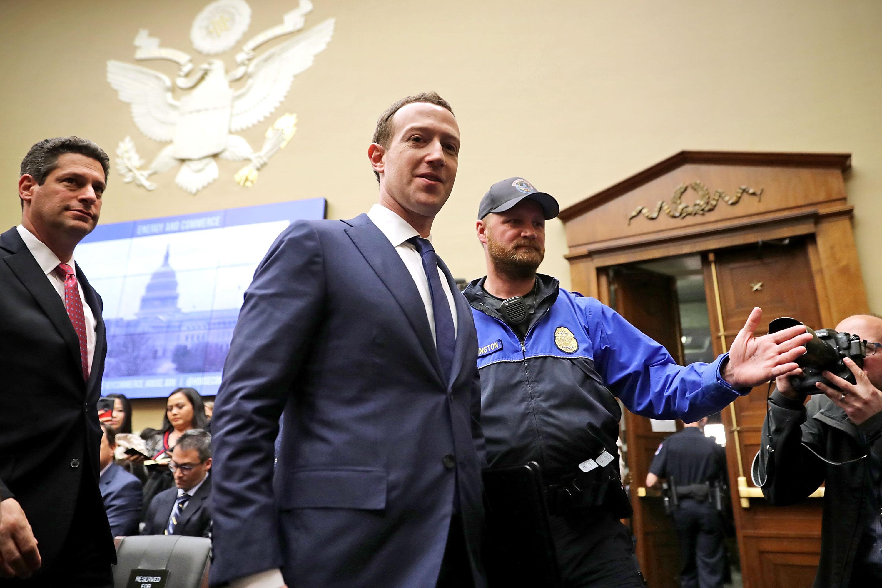 WASHINGTON, DC - APRIL 11:  Facebook co-founder, Chairman and CEO Mark Zuckerberg (C) leaves during a break in a hearing of the House Energy and Commerce Committee in the Rayburn House Office Building on Capitol Hill April 11, 2018 in Washington, DC. This is the second day of testimony before Congress by Zuckerberg, 33, after it was reported that 87 million Facebook users had their personal information harvested by Cambridge Analytica, a British political consulting firm linked to the Trump campaign.  (Photo by Chip Somodevilla/Getty Images)