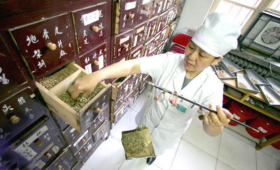 A doctor prepares a Chinese herbal medicine.