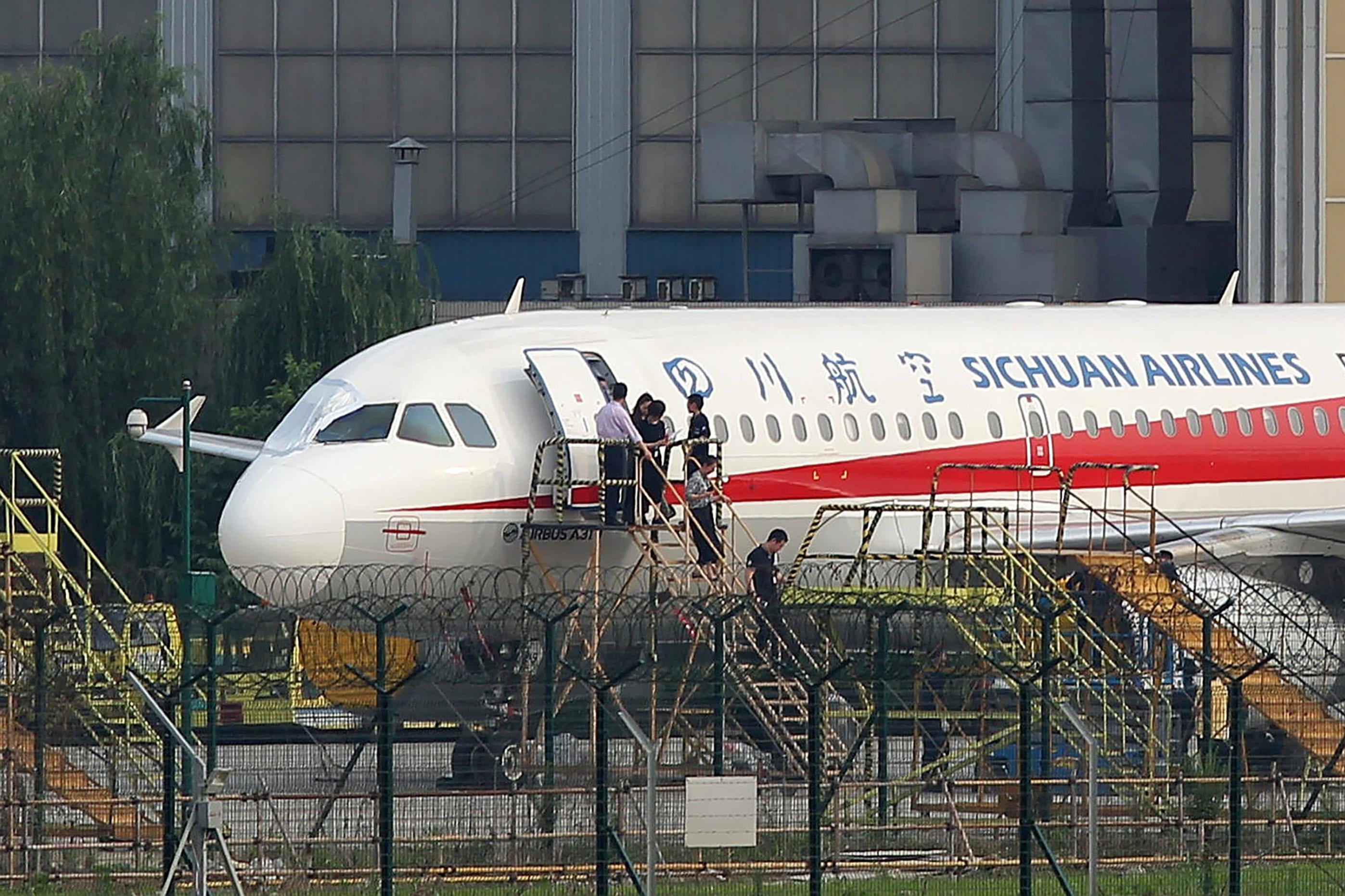 Employees check the Sichuan Airlines Airbus A319.