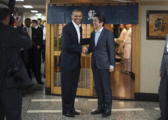 President Obama (L) shakes hands with Japanese Prime Minister Shinzo Abe.