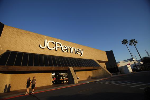 A couple walks by a J.C. Penney store in Arcadia, California March 1, 2013.