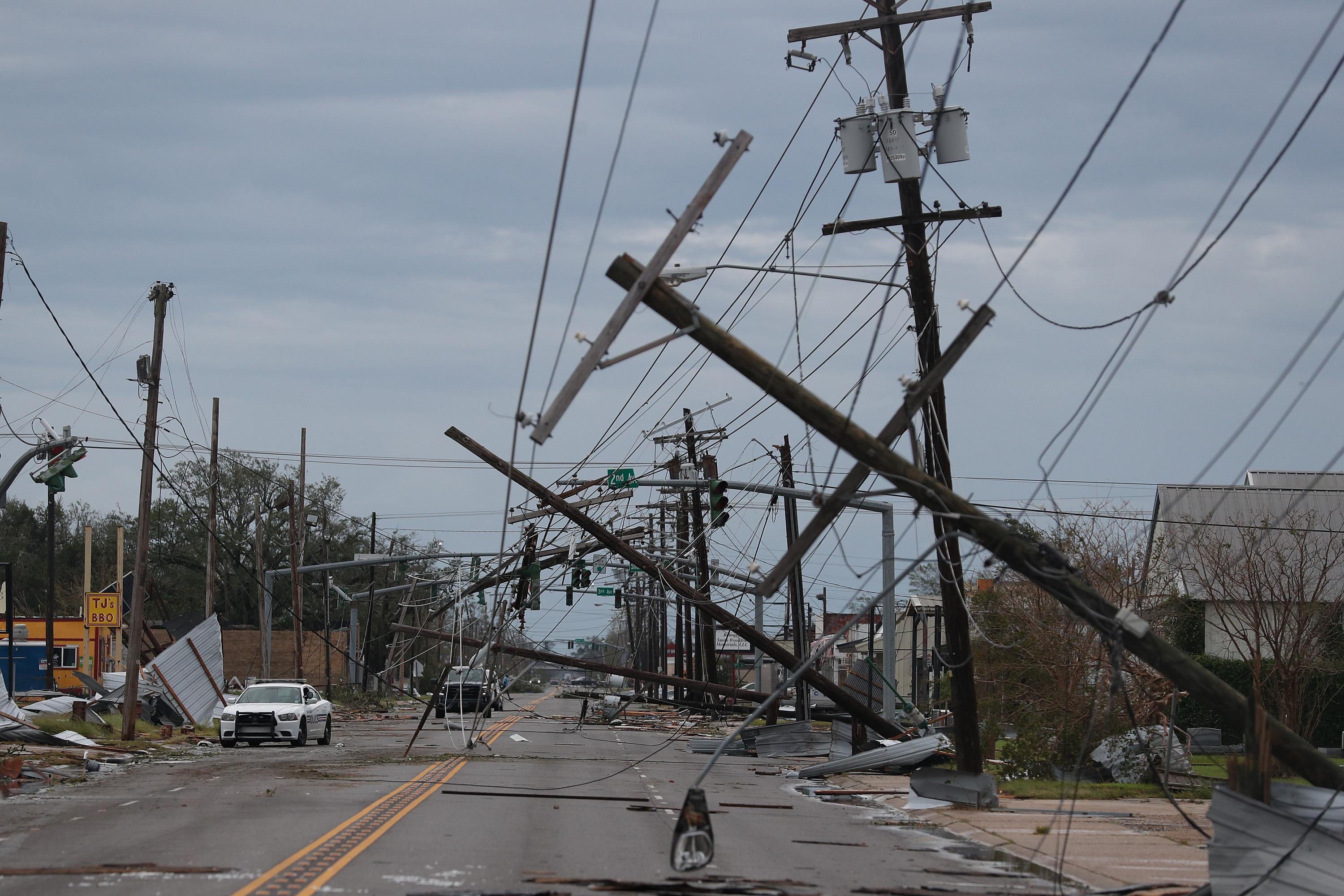 A street is seen strewn with debris and downed power lines.