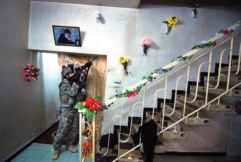 Staff Sgt. Zebadiah Thomas, of C Co., 3MUSSAYYIB, Iraq—Staff Sgt. Zebadiah Thomas, of C Co., 3-7 Infantry, watches a stairwell as his squad checks the rest of the house for a fleeing suspect, March 9, 2008.-7 Infantry, watches a stairwell as his squad checks the rest of the house for a fleeing suspect in Musayyib, Iraq, March 9, 2008.