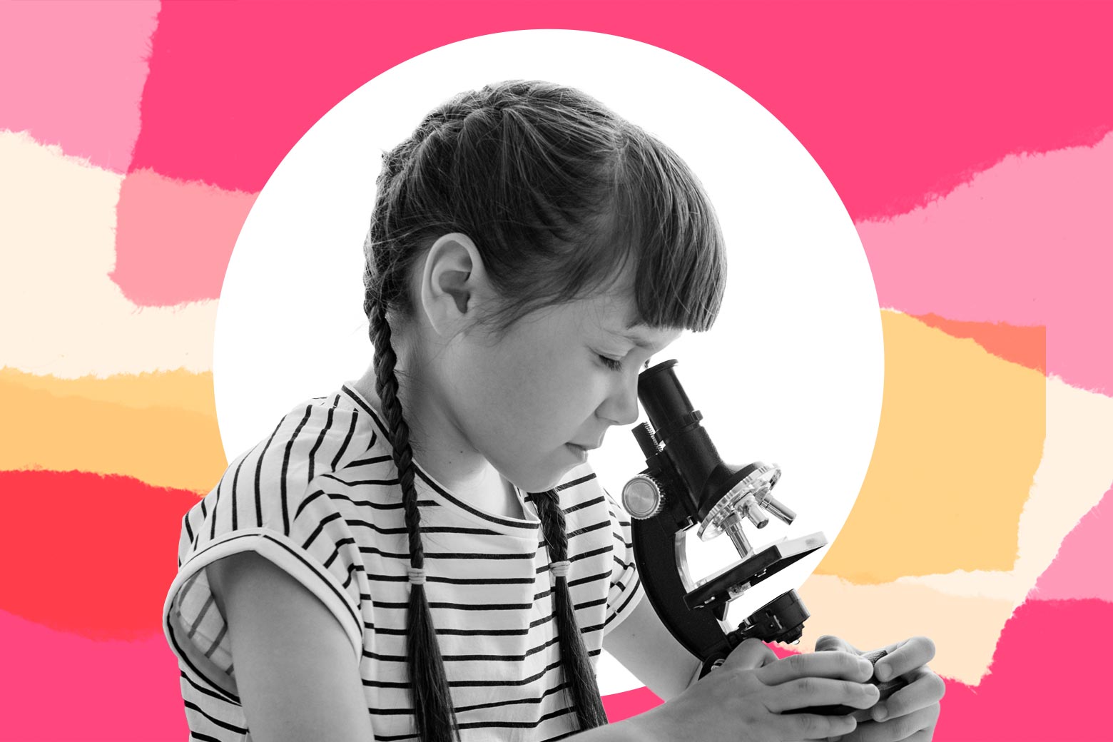 A girl looks through a microscope.
