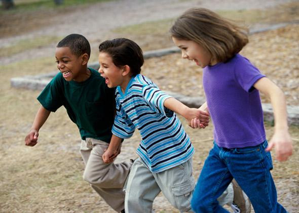 diverse kids playing on playground