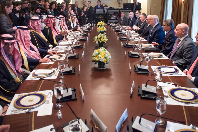 The Saudi delegation seated on one side of a long conference table, Trump and his aides on the other.