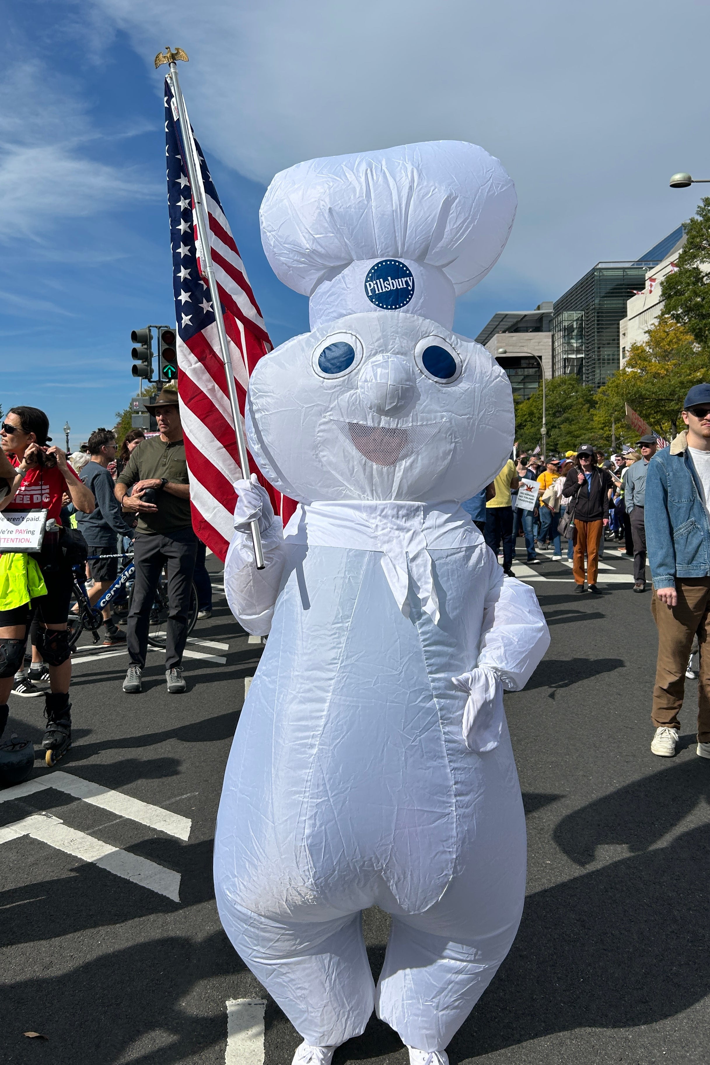 an inflatable Pillsbury dough boy holding an American flag.