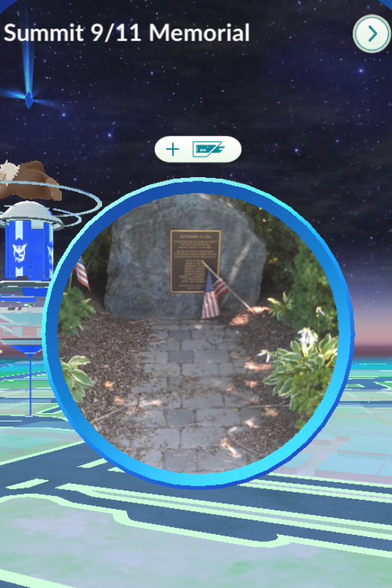 A screenshot with a photo of a memorial plaque in the center of a blue circle. Above is text that reads "Summit 9/11 Memorial."