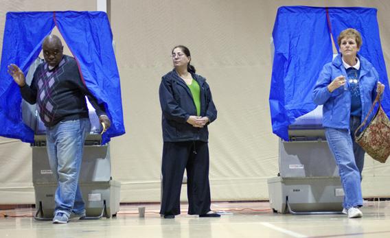 Voters leave voting booths after casting ballots