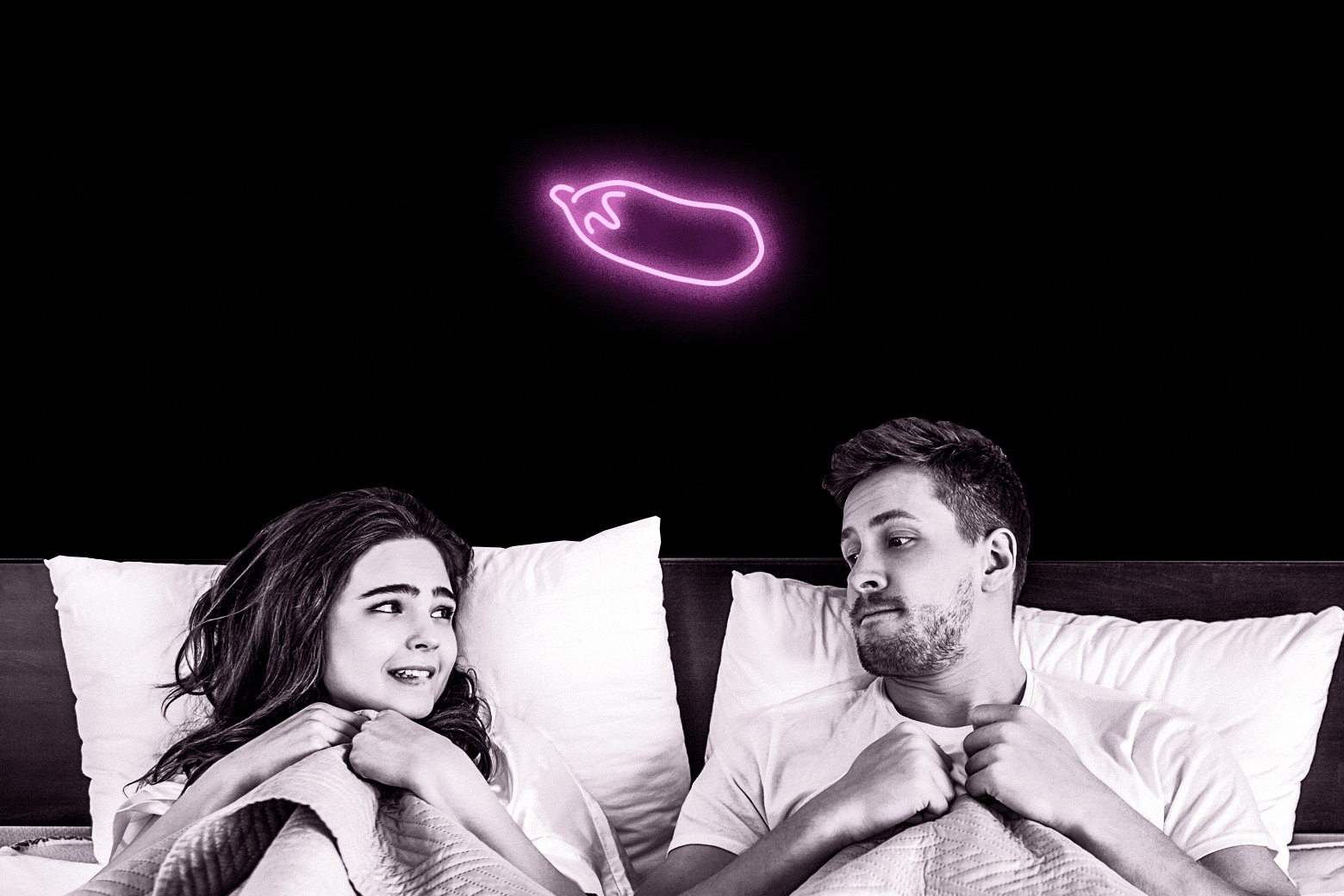 A man and woman looking timid in bed. A small neon eggplant hangs above them.