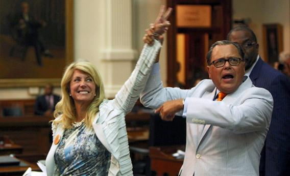 State Sen. Jose Rodriguez (D-El Paso) (R) celebrates with State Sen. Wendy Davis (D-Ft. Worth) (3L) as the Democrats defeat the anti-abortion bill SB5.