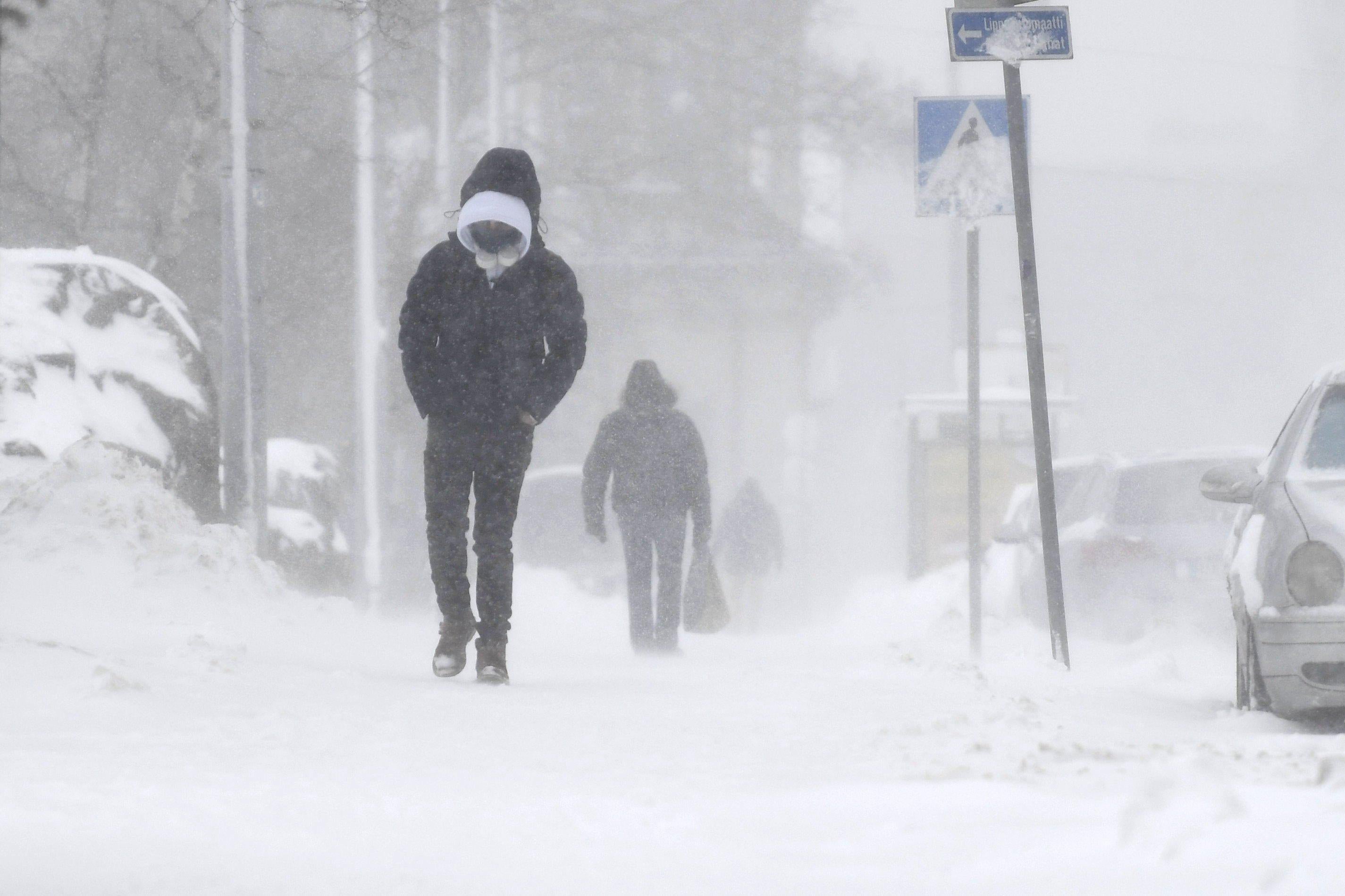 A man walking alone through a blizzard.