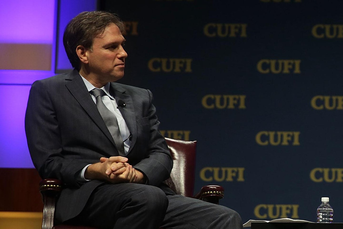 New York Times opinion columnist Bret Stephens looks to his left.