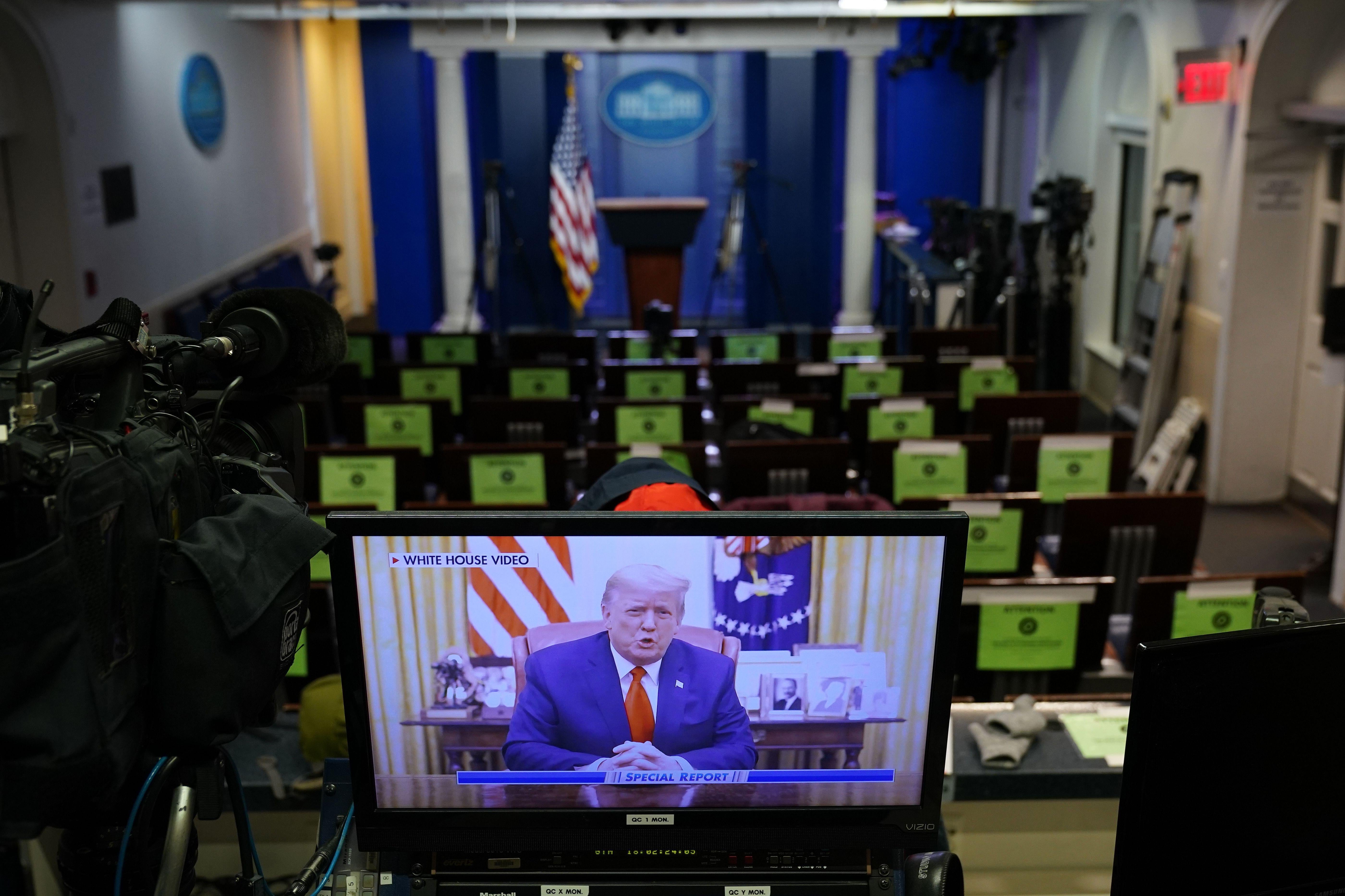 An image on a monitor shows President Donald Trump speaking during in a video posted on the White House Twitter feed, in the empty Brady Briefing Room of the White House in Washington, D.C. on January 13, 2021. 