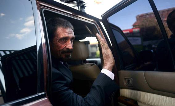 US anti-virus software pioneer John McAfee waves to journalists while leaving, in front of the Supreme Court in Guatemala.
