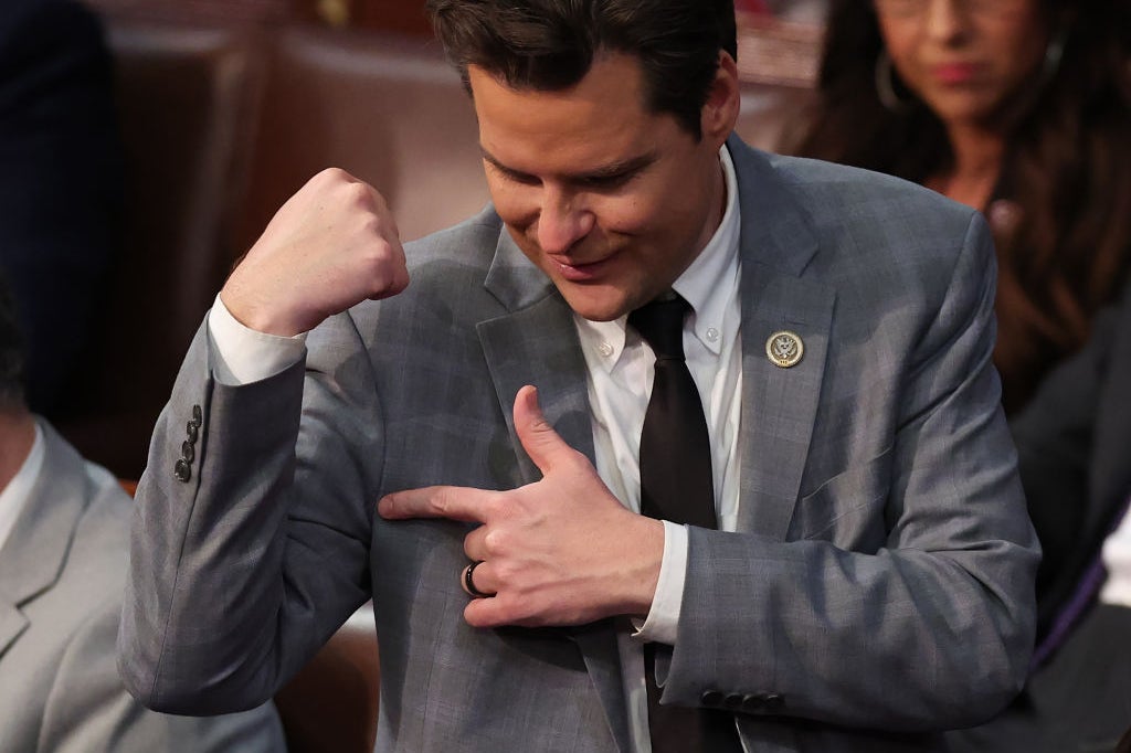 A close-up shot of Gaetz, who is flexing and pointing to his bicep.