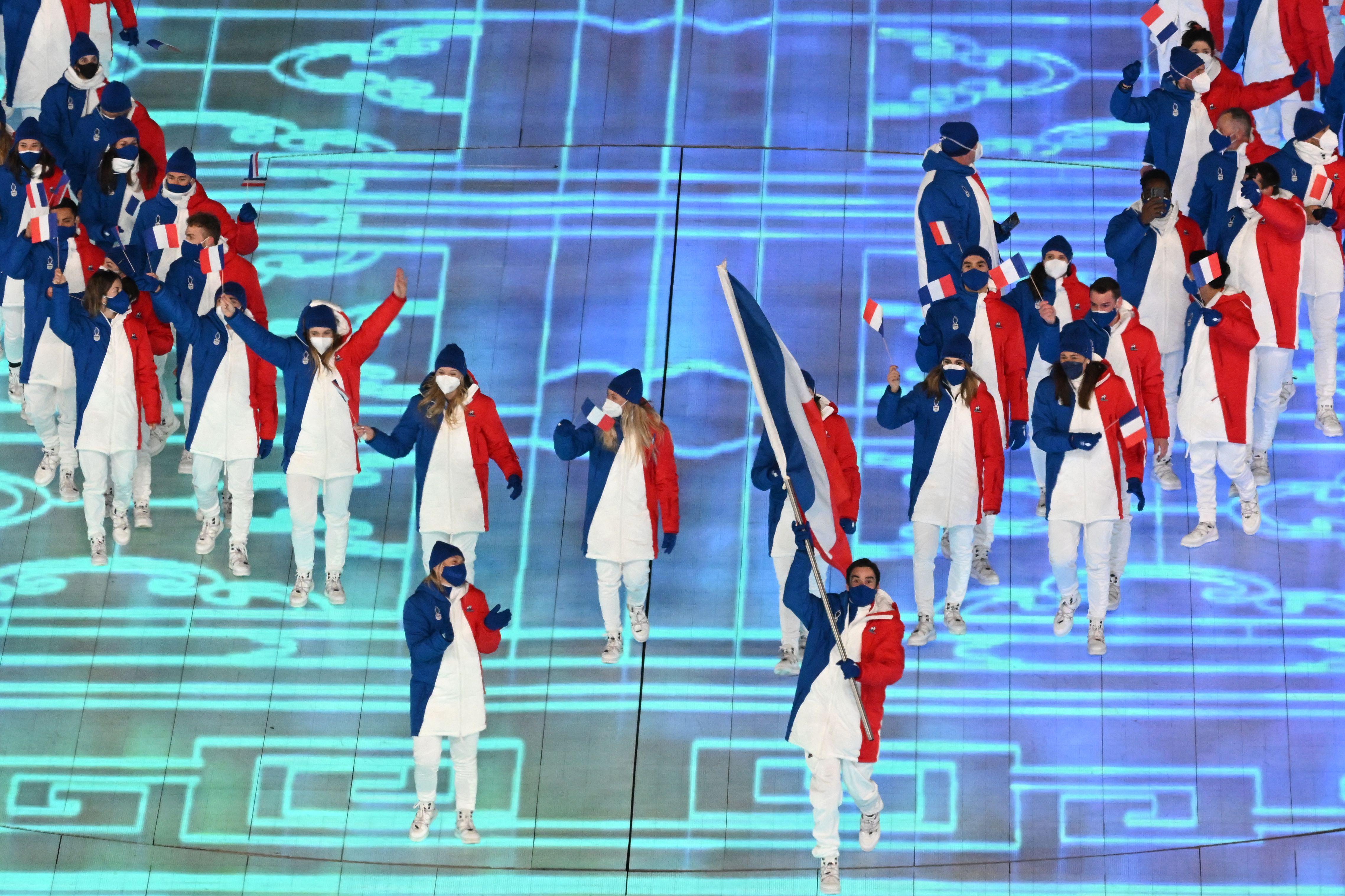 France's delegation marches in a group.