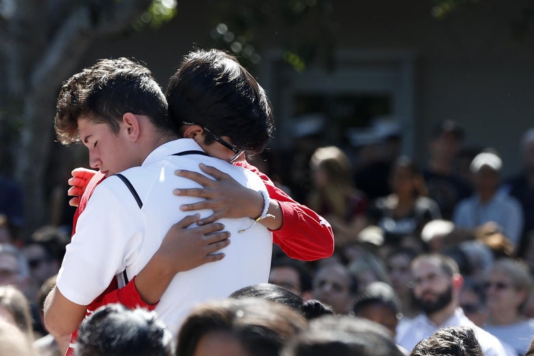 Mourners hug during a prayer vigil for the victims of the Marjory Stoneman Douglas High School shooting at Parkridge Church in Coral Springs, Florida, on Thursday.