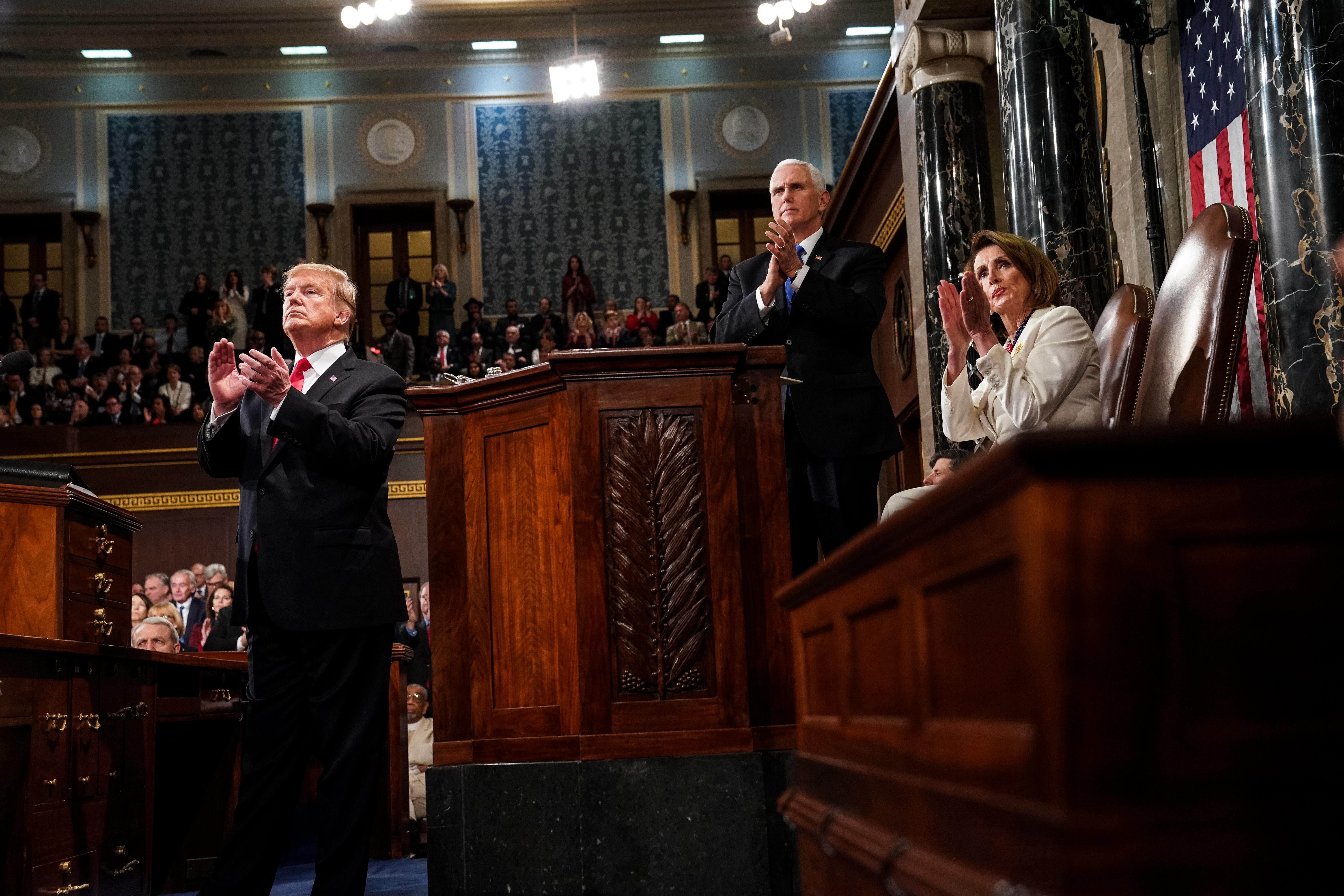 U.S. President Donald Trump, House Speaker Nancy Pelosi, and Vice President Mike Pence applaud during the State of the Union address on Tuesday in Washington.
