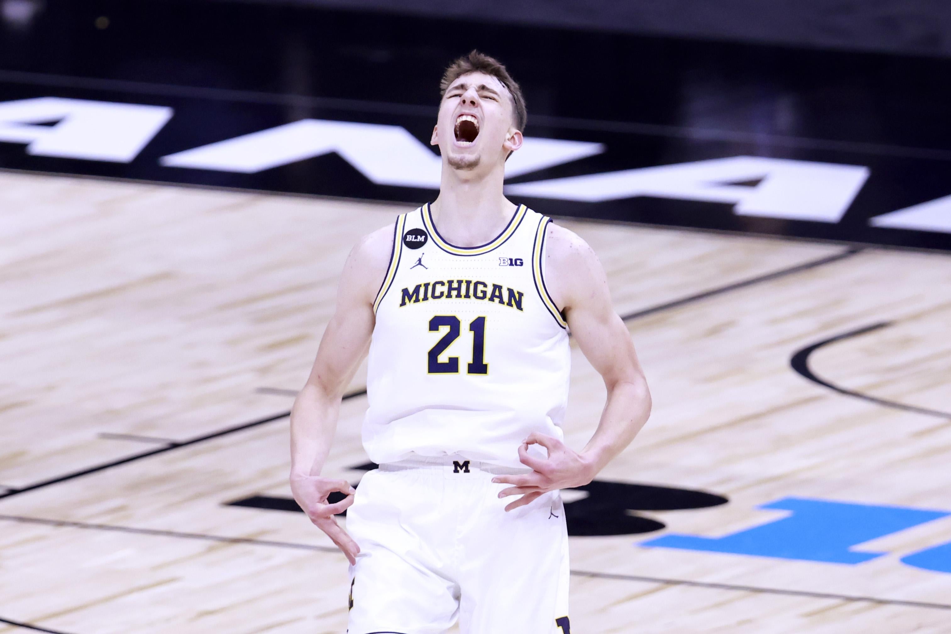 Franz Wagner of Michigan basketball yells in the air.