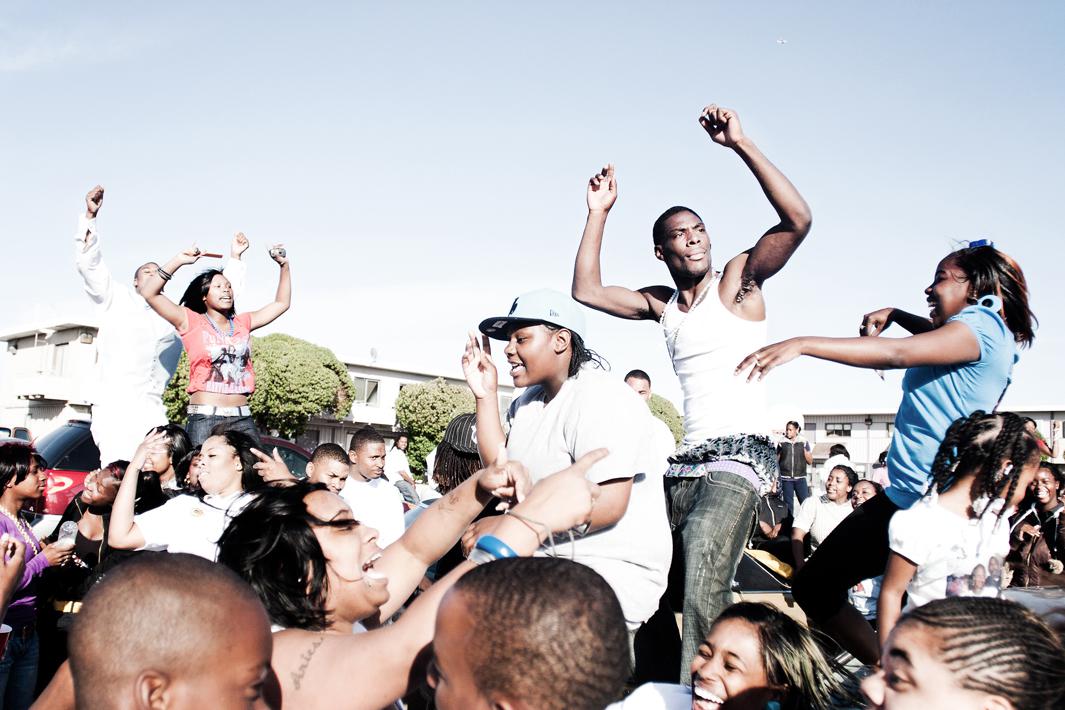 Residents of Hunters View celebrate the life of Martel 'Gully' Peters with a dance party on the block after his funeral. Peters was shot 16 times in the Army street projects. His brother, 'Nook' and his sister 'Tati' moved out of Hunters View shortly after.