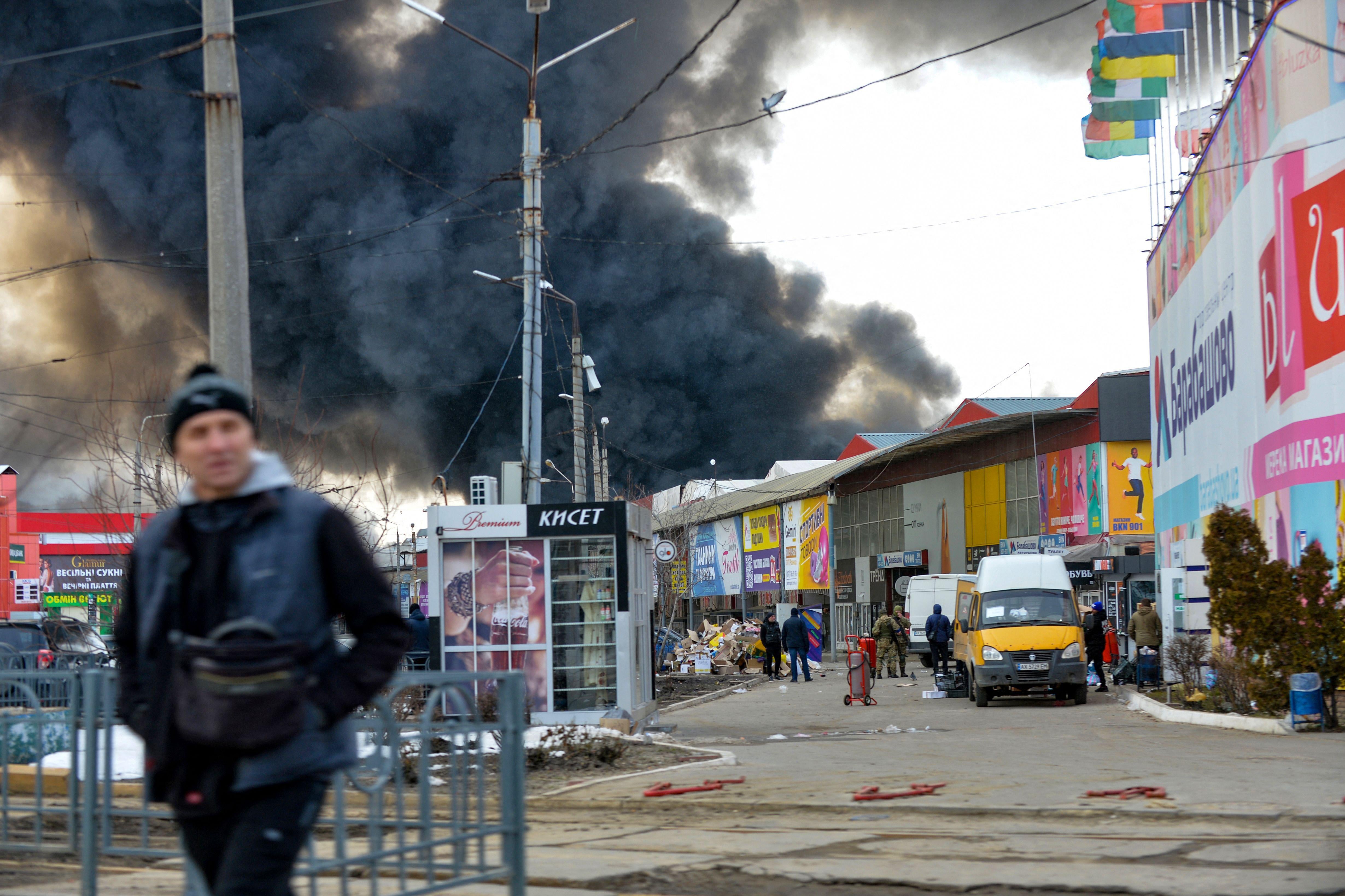 Black smoke rises into the sky above a market after a bombing