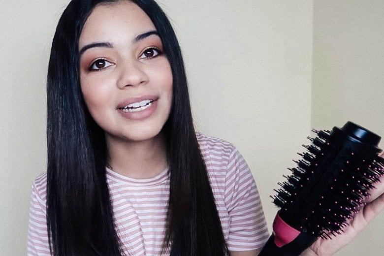 Julissa Guillen holds the hair dryer in a still image from her YouTube video.
