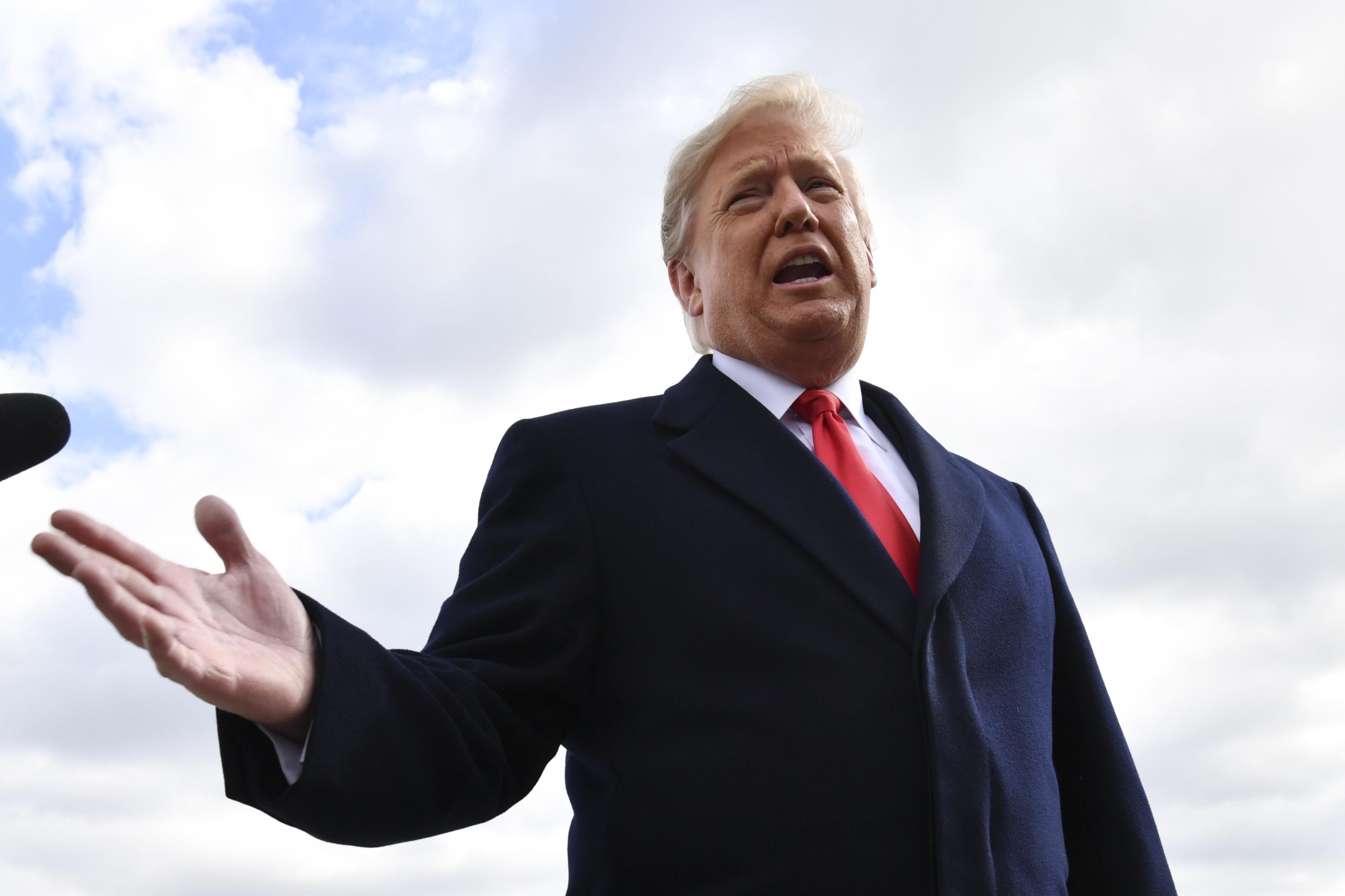 President Donald Trump speaks with reporters after landing at Indianapolis International Airport on October 27, 2018 in Indiana.