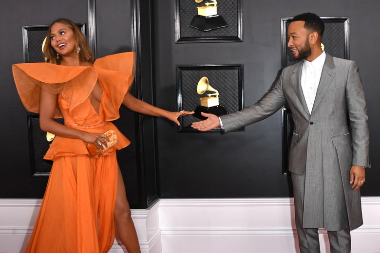 US model Chrissy Teigen (R) and US musician John Legend arrive for the 62nd Annual Grammy Awards on January 26, 2020, in Los Angeles. (Photo by VALERIE MACON / AFP) (Photo by VALERIE MACON/AFP via Getty Images)
