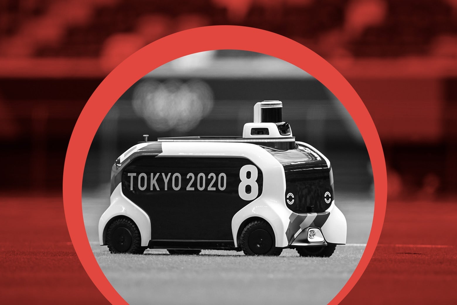 A robot shaped like a little bus with a squat cylinder on top at the front on a field, encircled by an illustration highlighting it 