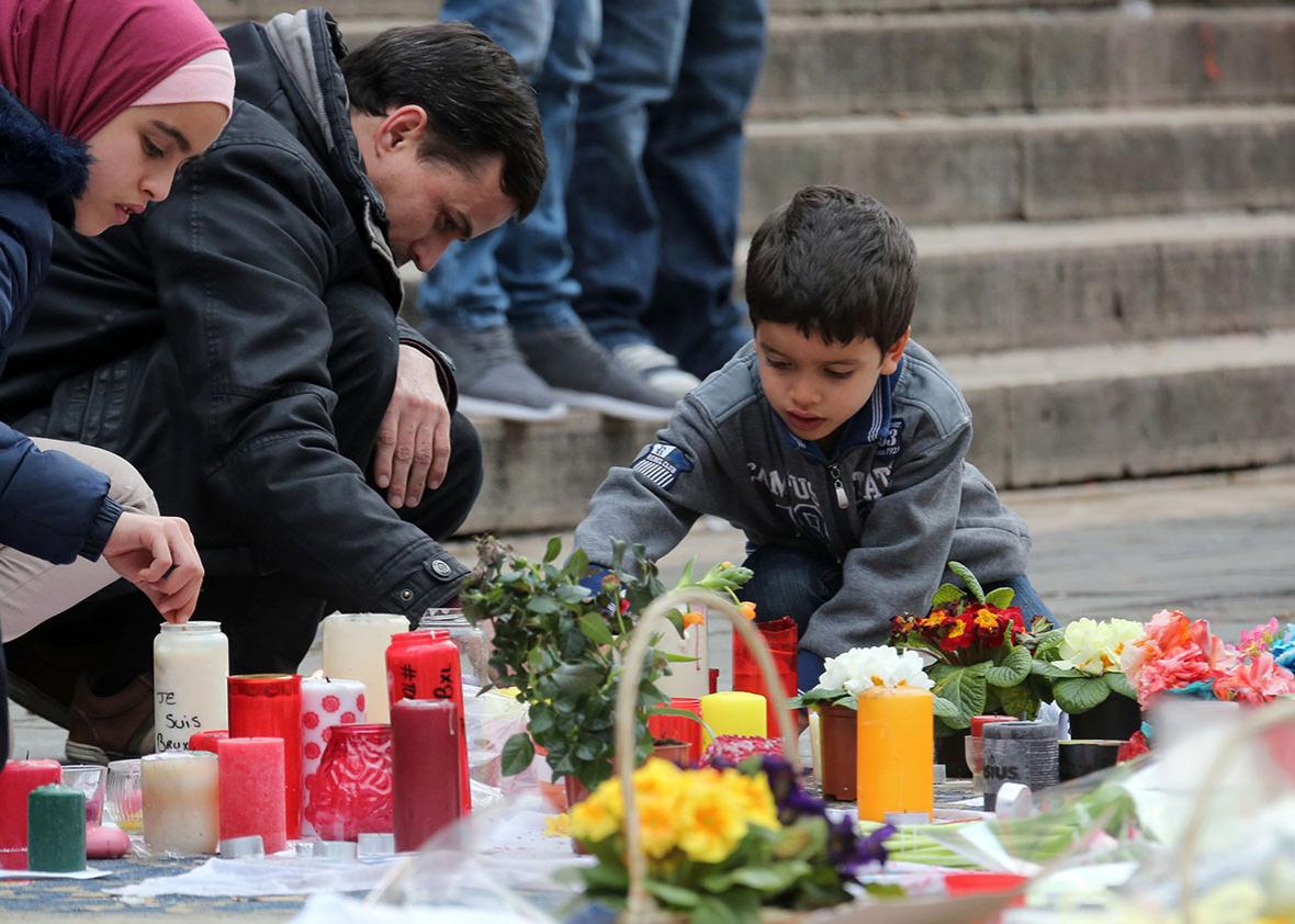 People gather in the Place de la Bourse in Brussels on Sunday to pay tribute to the victims of last week’s attacks.