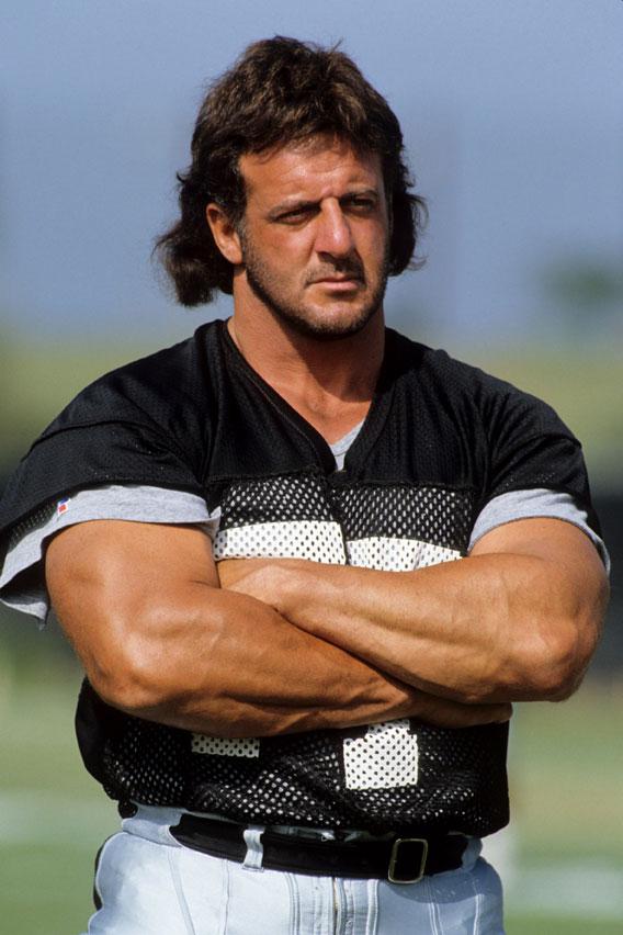 Lyle Alzado #77 of the Los Angeles Raiders looks on during August of 1990 training camp in Oxnard, California.