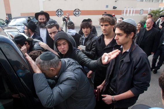 Relatives and mourners attend a ceremony at 'Ozar Hatorah' Jewish school.