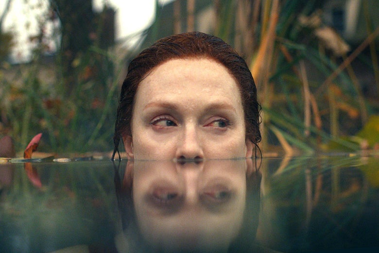 Julianne Moore, her head half submerged in a pond.