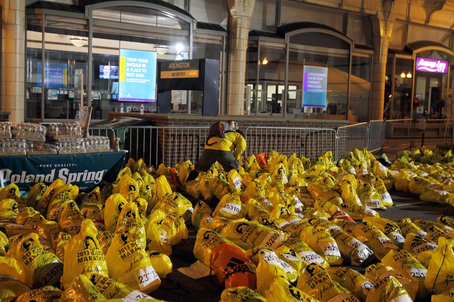 A runner looks through unclaimed runners' bags from the Boston Marathon in Boston, Massachusetts.