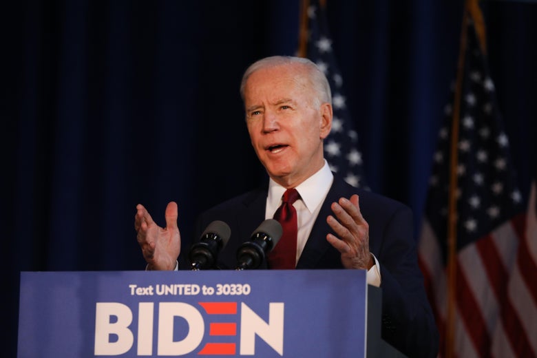 Joe Biden speaks and gestures at a lectern.