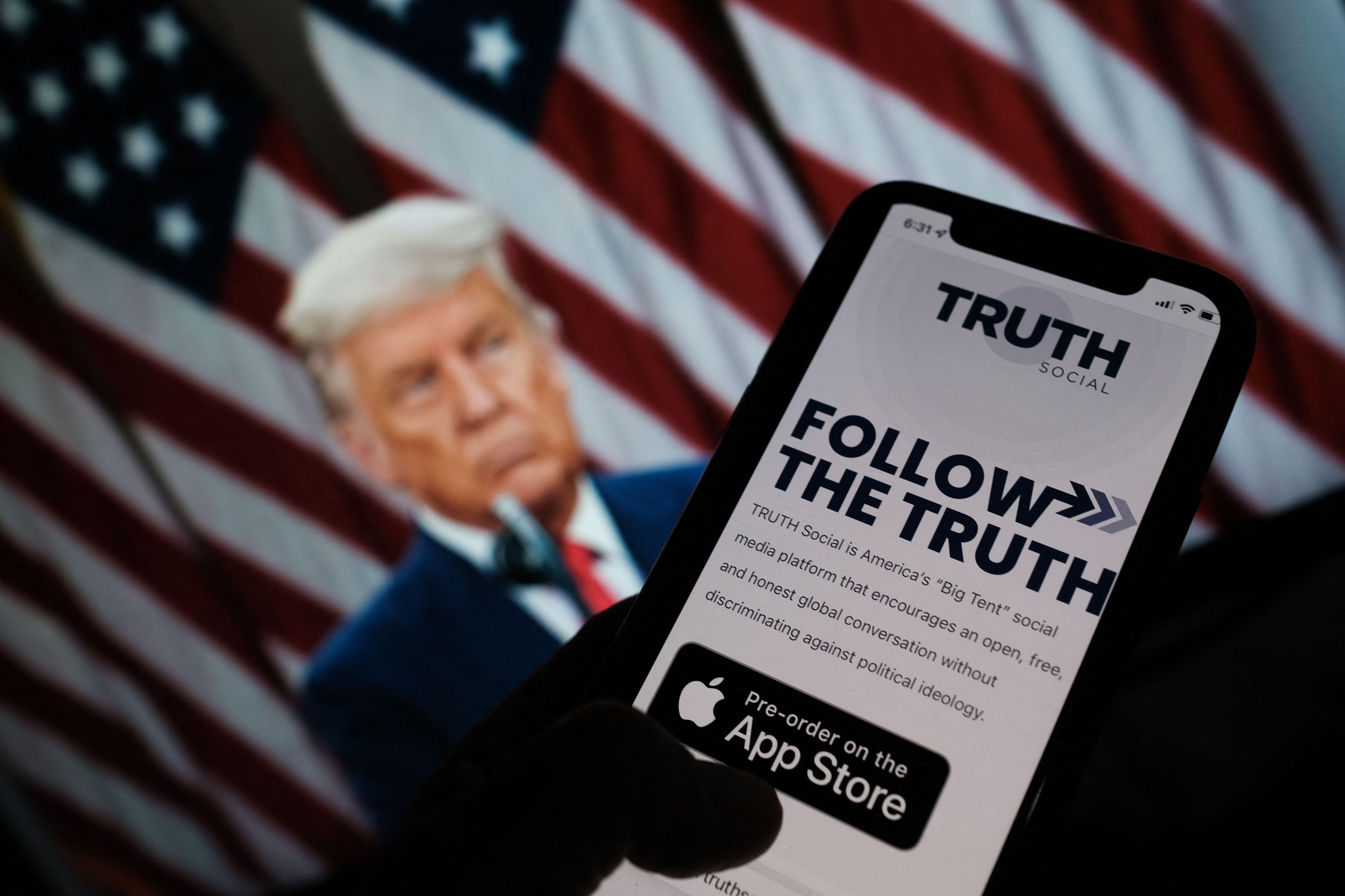 This illustration photo shows a person checking the app store on a smartphone for "Truth Social."